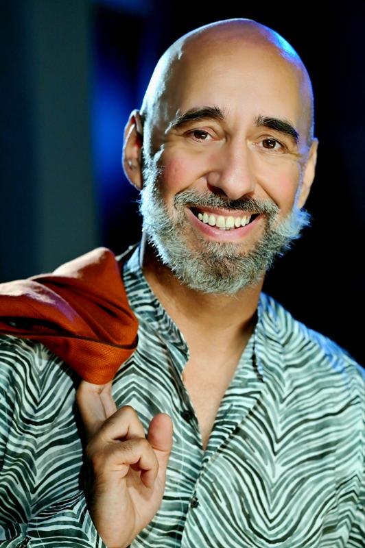 Andreas Pliatsikas smiling in a patterned shirt